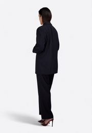 Back view of model wearing black linen open-front blazer, East Vibe